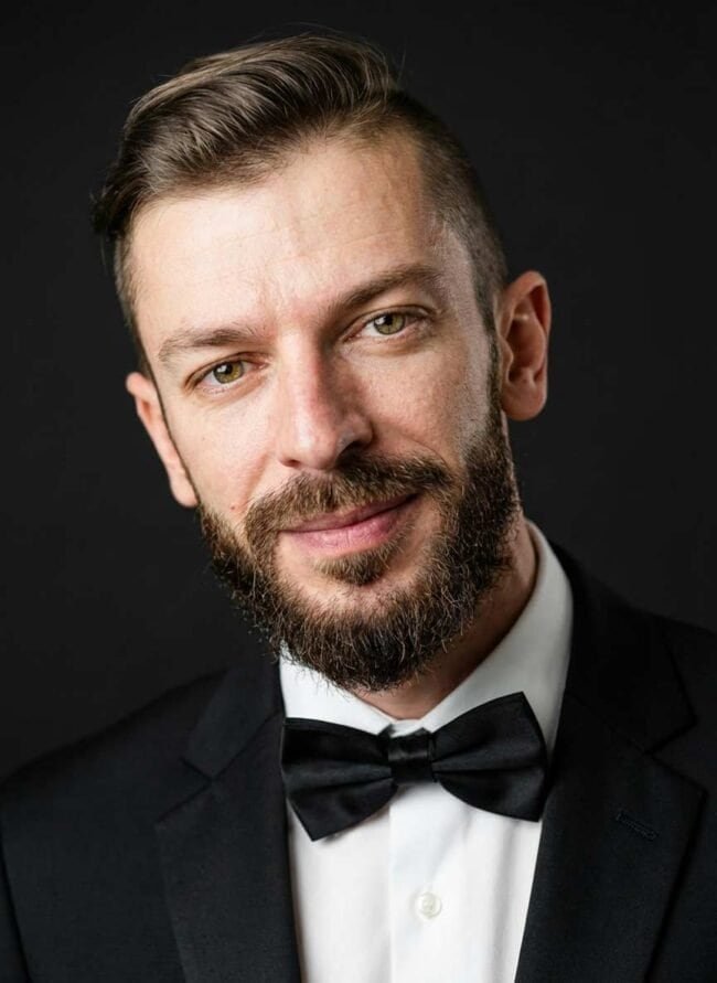 Elegant male portrait in tuxedo with bow tie, professional headshot for AI photographers.